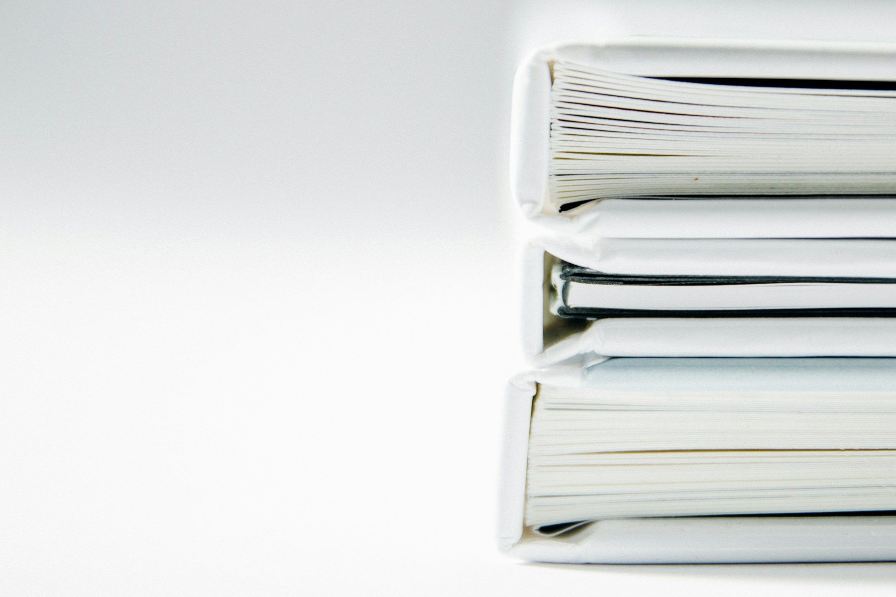 Pilha de pastas de documentos contábeis e fiscais sobre superfície clara